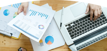 Manos de una persona en un escritorio lleno de papeles