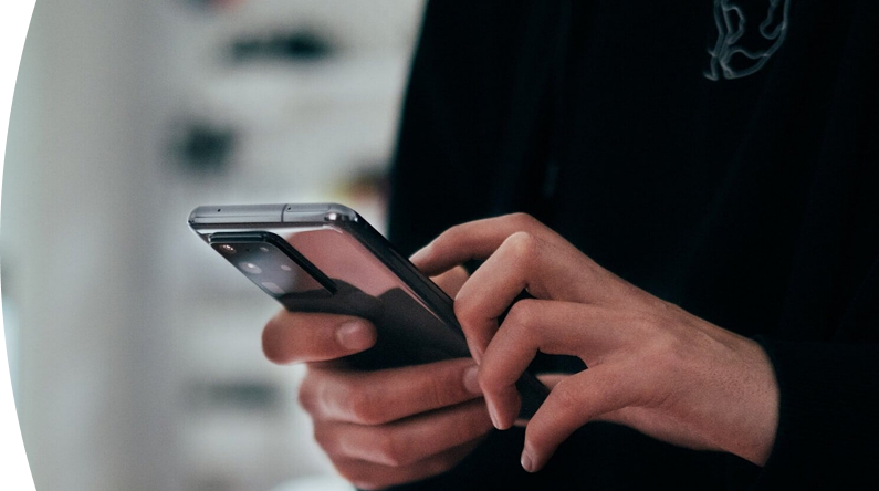 Person holding and using a mobile phone.