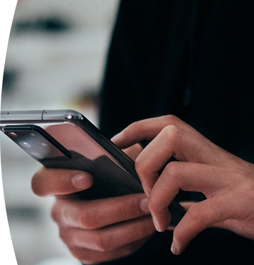 Person holding and using a mobile phone.