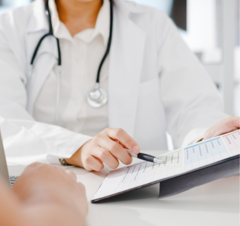 Profesional de la salud con bata blanca y estetoscopio, sosteniendo una tableta o documento.