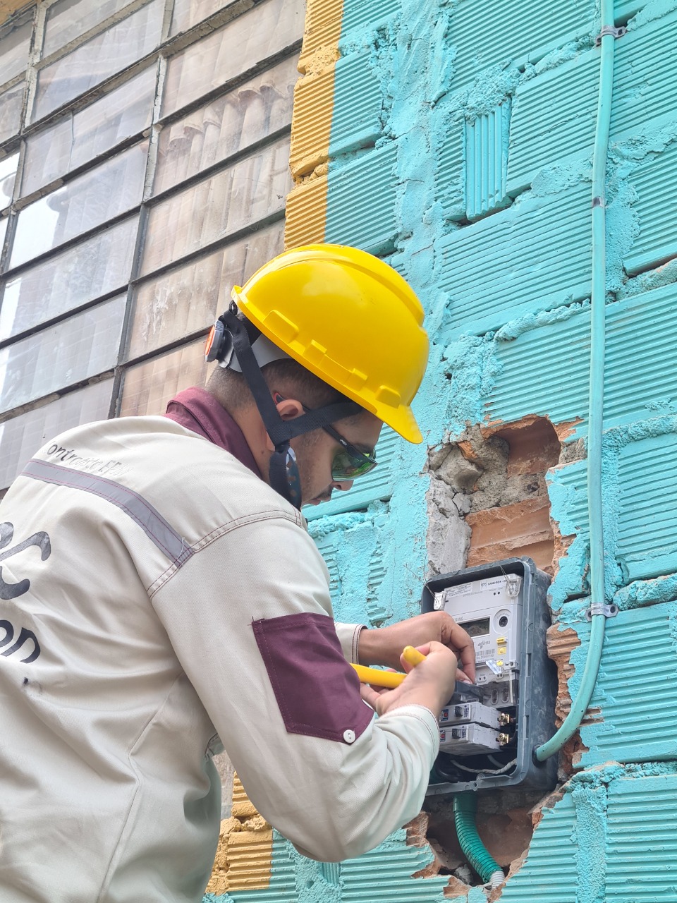 Trabajador de EPM arreglando un contador de energía