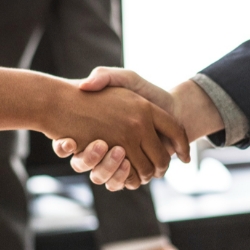 Dos personas estrechan la mano en señal de acuerdo