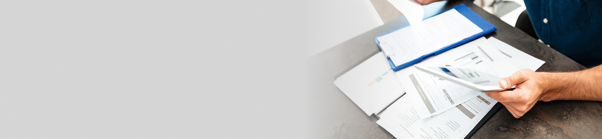 Person working with a stack of papers