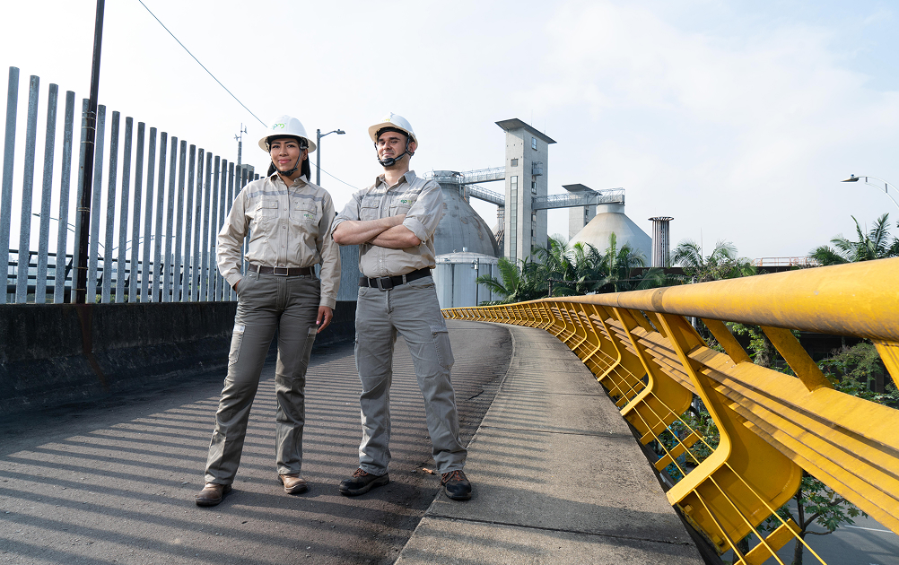 Two EPM's employees smiling and posing on a bridge