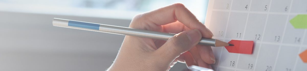 Image of a person making notes on a calendar